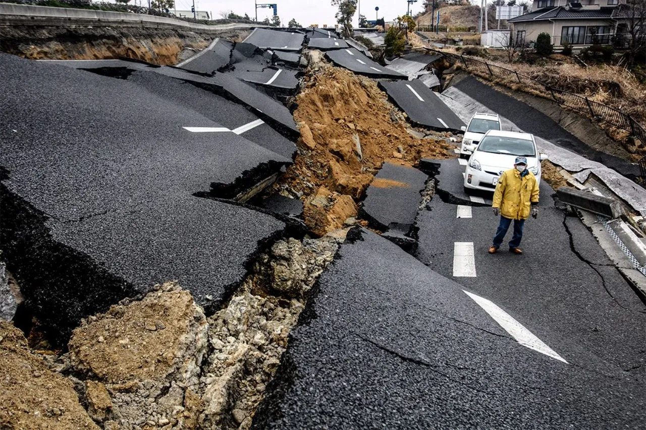 A man walks in a destroyed street in the devastated city of Ishinomaki on April 15, 2011 following the deadly March 11 earthquake and tsunami that hit the northeastern coast of Japan's main island of Honshu. (Photo by Hitoshi Yamada/NurPhoto) (Photo by NurPhoto/NurPhoto via Getty Images)