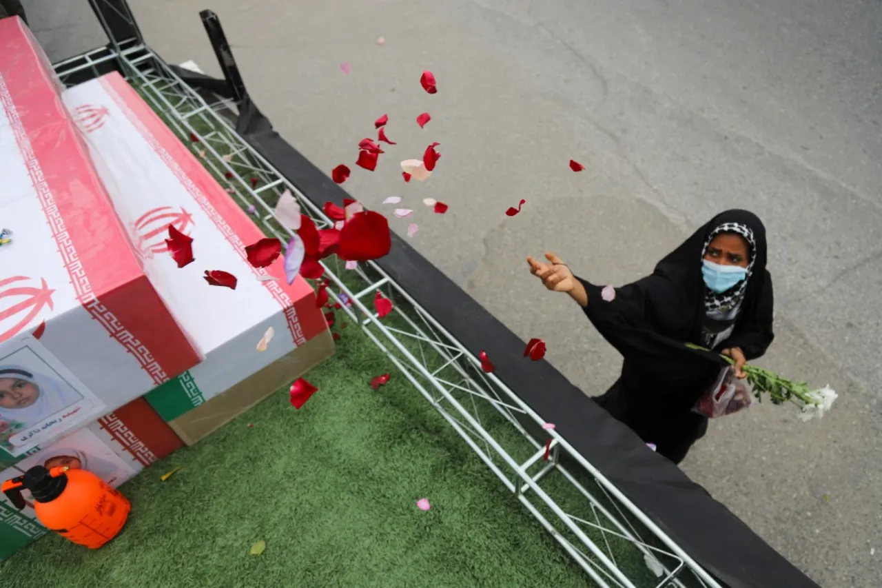 In this picture obtained from Iran's ISNA news agency, a mourner sprays flower petals on the coffins of children who were killed in a reported strike on a primary school in Iran’s Hormozgan province during a funeral in Minab on March 3, 2026. Iranian media have reported hundreds of Iranian casualties, including at a girl's school, although AFP reporters have not been able to verify tolls independently. The war launched by the United States and Israel against Iran spread across the Middle East, threatening to plunge the global economy into chaos, with Lebanon and Gulf energy exporters dragged into the conflict. (Photo by AMIRHOSSEIN KHORGOOEI / ISNA / AFP)