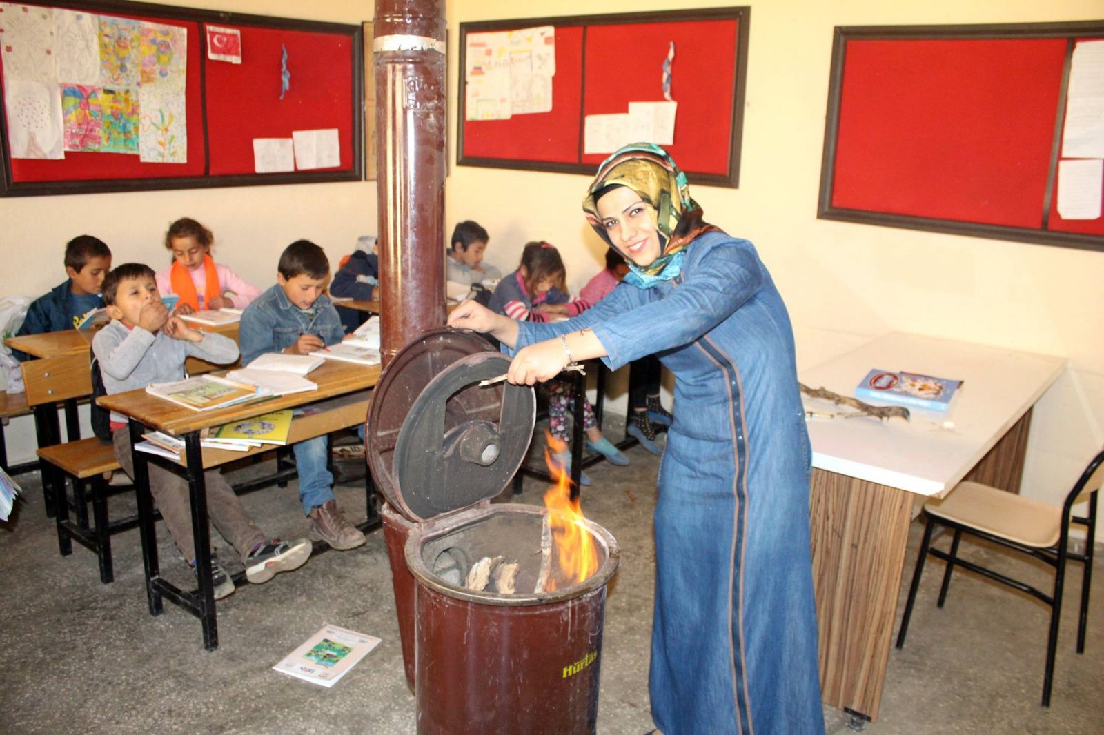 Ayşe öğretmen odun topluyor, sobayı yakıyor, sınıfları temizliyor
