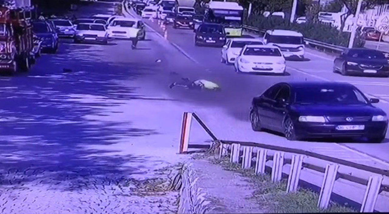 Kendisini durdurmak isteyen trafik polisini otomobiliyle metrelerce sürükledi