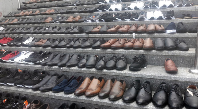 Eminönü’nde esnaf, su baskınından kurtardığı ayakkabıları merdivenlere serdi