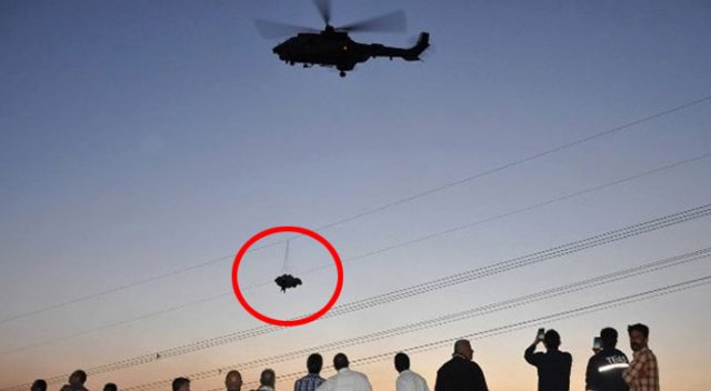 Tellere takılan paraşütçü, helikopterin rüzgarıyla yere düştü