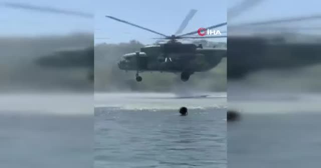 Ukrayna'da askeri helikopter tatilcilerin arasında tatbikat yaptı
